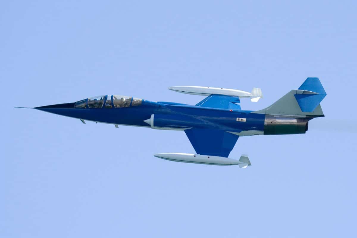 Avion de chasse bleu en vol.