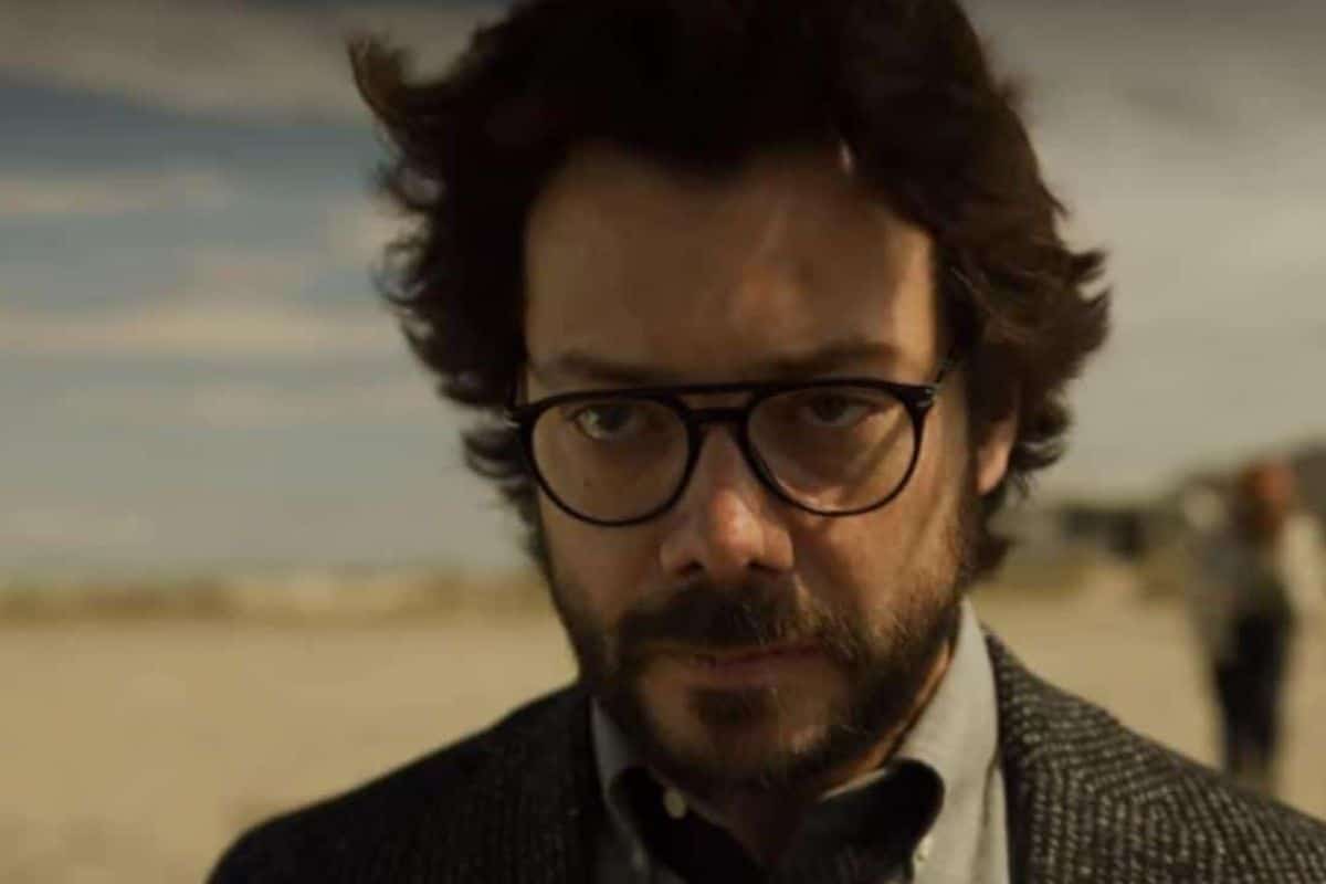 Homme barbu avec lunettes sur la plage.