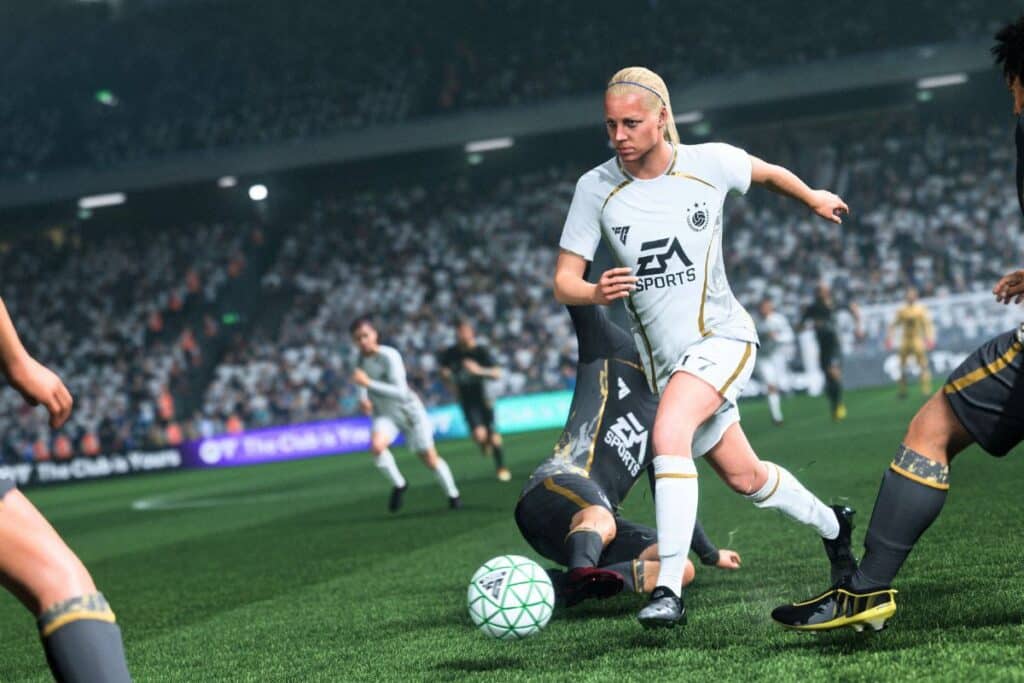 Joueur de football dribblant sur le terrain.