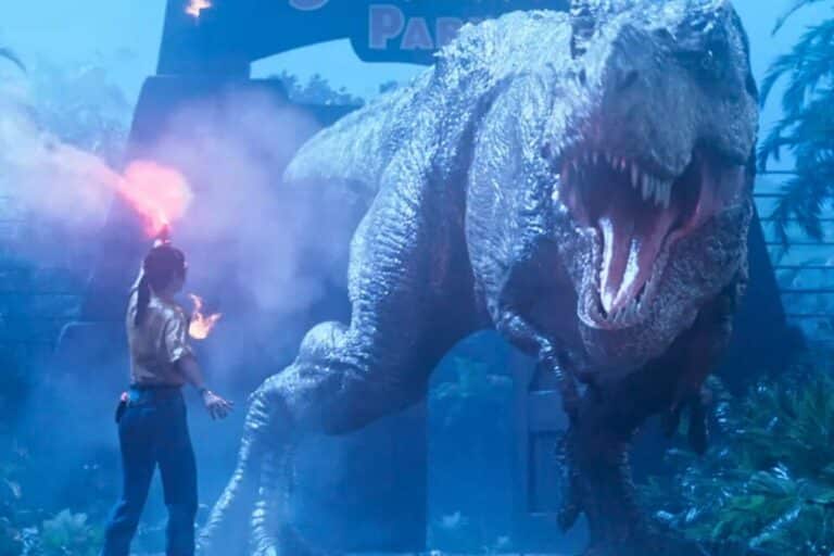 Homme avec une torche face à un dinosaure.