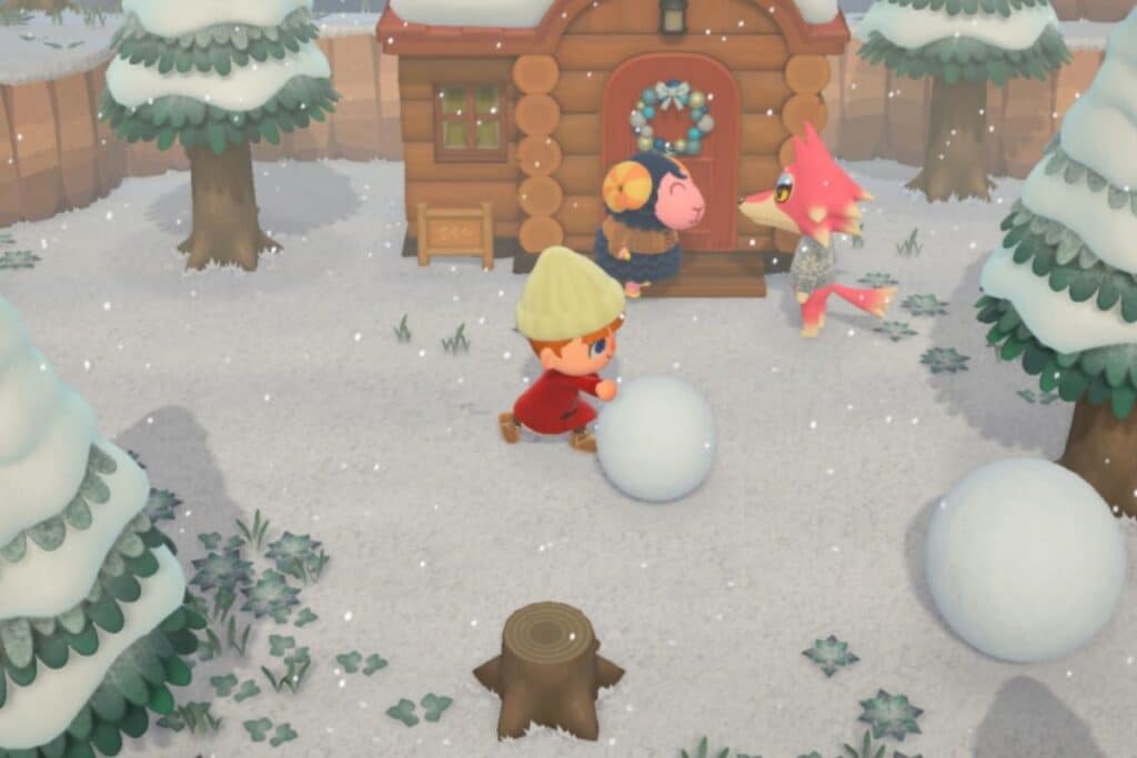 Personnage fait une boule de neige devant une cabane.
