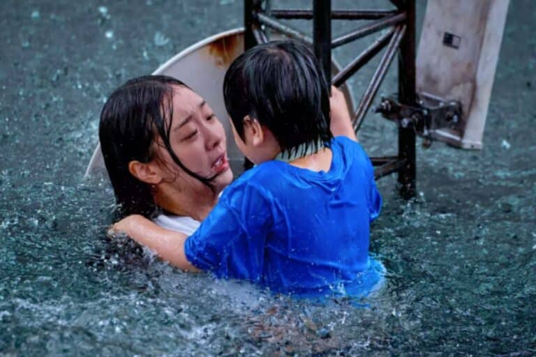 Deux personnes dans l'eau sous la pluie.