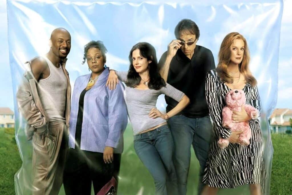 Cinq personnes posant devant un fond transparent.