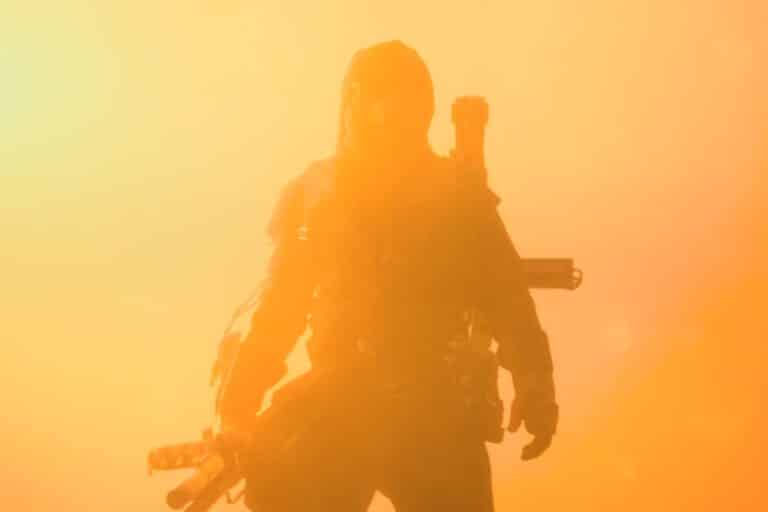 Figure sombre dans une ambiance orangée apocalyptique.