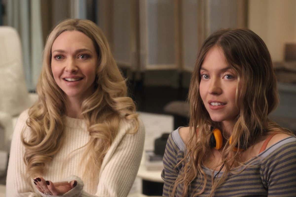 Deux femmes souriantes assises ensemble.