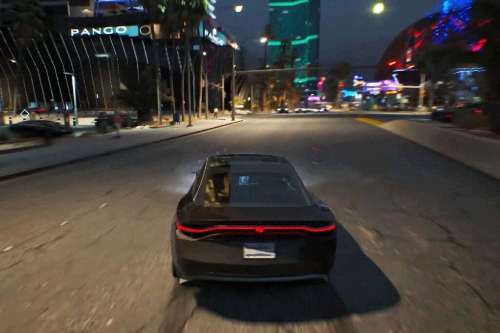 Voiture noire sur route de nuit éclairée.